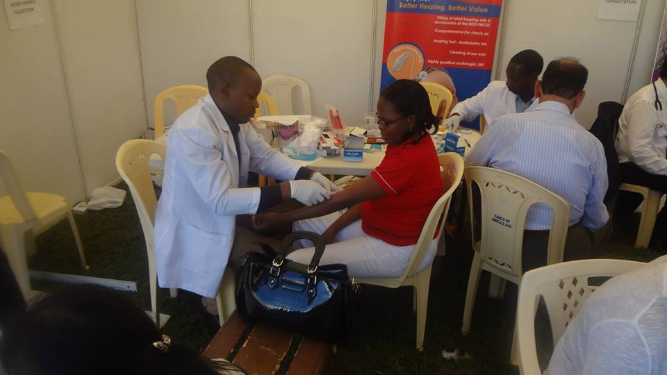 A staff member taking a shot at the medical check up tent